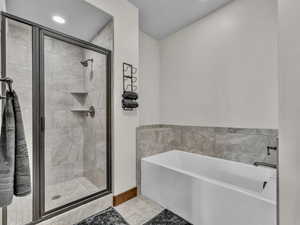 Full bathroom with a stall shower, a garden tub, recessed lighting, and tile patterned floors