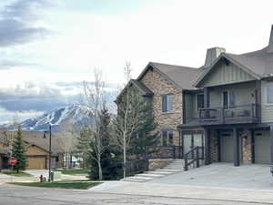 View of asphalt street featuring traffic signs and a mountain view