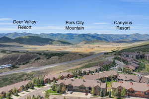 Aerial perspective of suburban area featuring a mountain backdrop