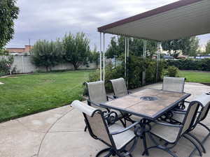 Fenced backyard with a patio area and outdoor dining space