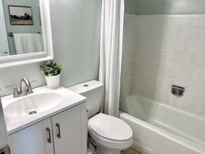 Full bathroom featuring shower / tub combo and vanity