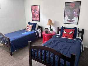 Bedroom featuring a textured wall and carpet floors