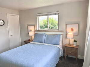 Bedroom with a textured ceiling and carpet floors