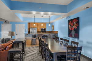 Dining area featuring a tray ceiling and recessed lighting
