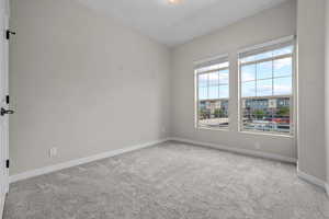 Unfurnished room with carpet and baseboards