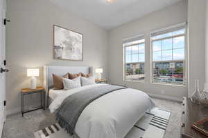 Carpeted bedroom featuring baseboards
