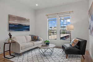 Living area with wood finished floors and recessed lighting