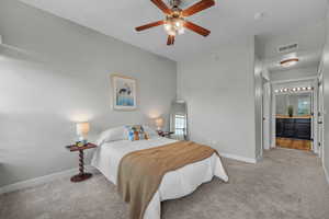 Carpeted bedroom featuring baseboards and ceiling fan