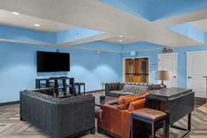 Living room with a textured ceiling and recessed lighting