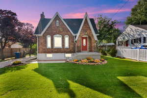 English style home featuring brick siding and a chimney