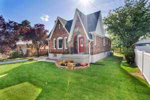 Tudor-style house featuring brick siding