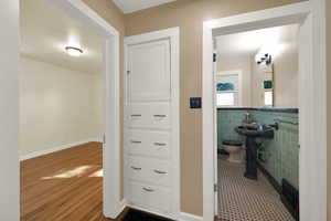 Bathroom featuring tile walls, wainscoting, and tile floors