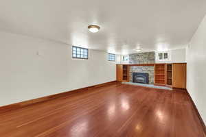 Nice sized family room featuring  hard wood floors and a cozy fireplace