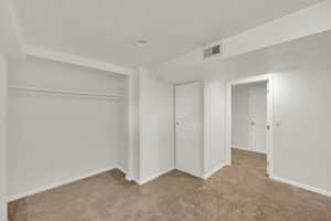 Bedroom with new light covered carpet and recessed lighting