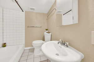Bathroom featuring  tile floors, shower / tub combination