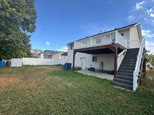 Back of property featuring a patio area, stairs, and a deck