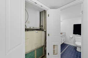Bathroom featuring vanity and dark tile patterned flooring