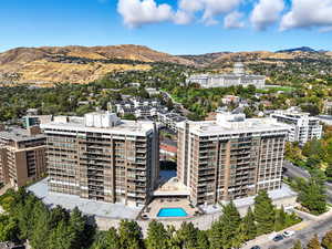 View of urban area with a mountainous background and a pool area