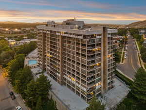 Property at dusk featuring a mountain view and a view of apartment building / complex