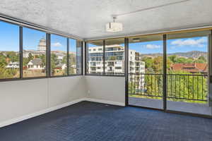 Unfurnished sunroom with a mountain view