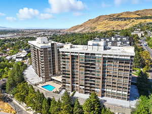 Aerial view of a mountainous background and apartment complex / building