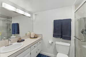Bathroom with tile patterned flooring, vanity, and a shower stall