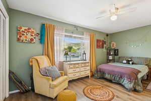 Bedroom with wood finished floors and ceiling fan