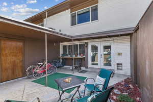 Back of property featuring a patio, french doors, and brick siding