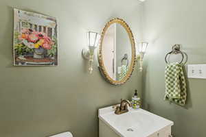 Bathroom with vanity and a textured wall