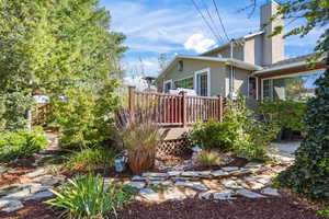 Stone pathways explore the tastefully designed backyard with a Trex deck and a patio areas.