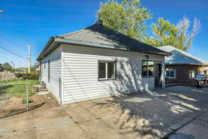Back of property with roof with shingles