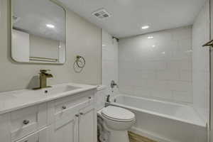 Full bath with shower / bathtub combination, vanity, recessed lighting, and light wood finished floors