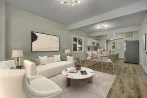 Living room with beam ceiling, light wood-style flooring, a textured ceiling, and a chandelier