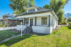 Bungalow with a porch and roof with shingles