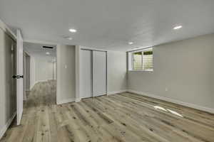 Unfurnished bedroom featuring recessed lighting, a closet, and light wood-type flooring