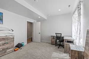 Bedroom area featuring light carpet and recessed lighting