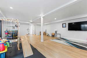 Family room with wood finished floors and recessed lighting