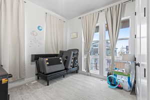 Bedroom featuring light colored carpet and baseboards