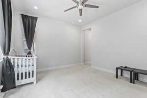 Unfurnished bedroom featuring light carpet, ceiling fan, and recessed lighting