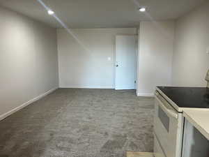 Unfurnished living room with light colored carpet and recessed lighting
