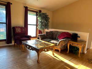 Living area featuring wood-type flooring and a textured ceiling