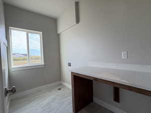Washroom featuring hookup for a washing machine and baseboards
