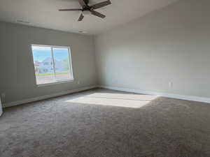 Empty room with carpet and ceiling fan