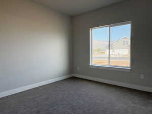 Spare room with carpet and a mountain view