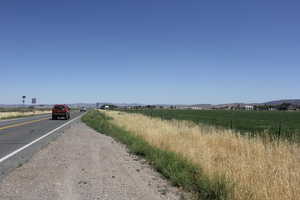 View of asphalt street with a mountain view and a view of rural / pastoral area