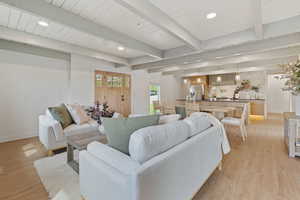 Living room with recessed lighting, light wood-style flooring, and beam ceiling