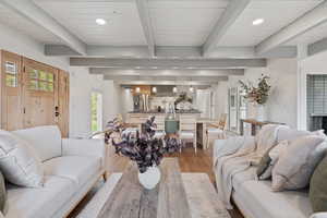 Living room featuring recessed lighting, light wood-type flooring, and beam ceiling