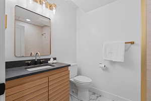 Bathroom with vanity, a shower, and marble finish floors