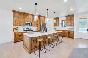 Large kitchen featuring a kitchen bar, pendant lighting, stunning, cabinetry, and recessed lighting
