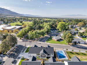 Aerial perspective of suburban area featuring open spaces and mountains